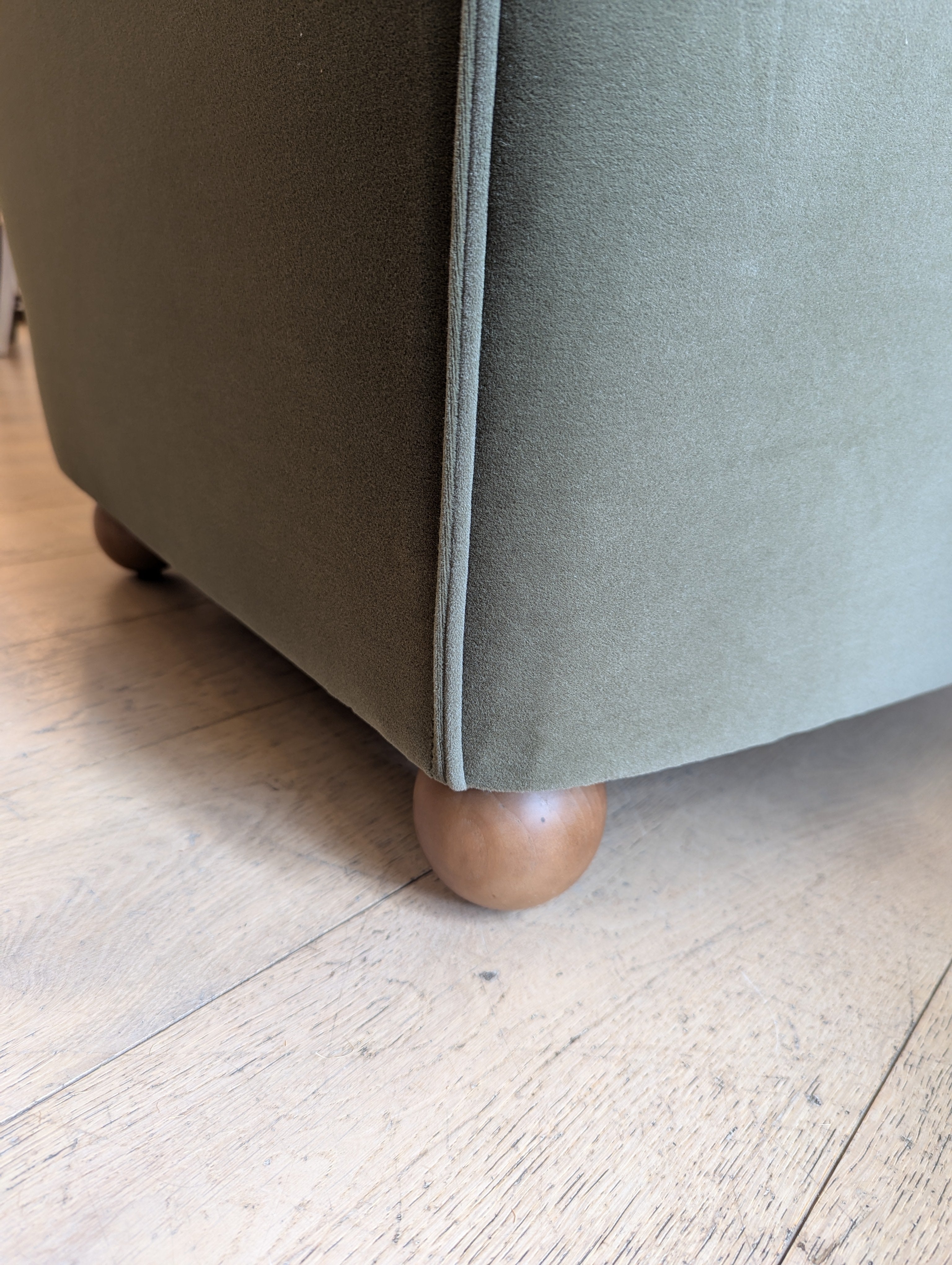 Felix Olive Armchair with a soft to the touch olive velvet and oak sphere legs. 