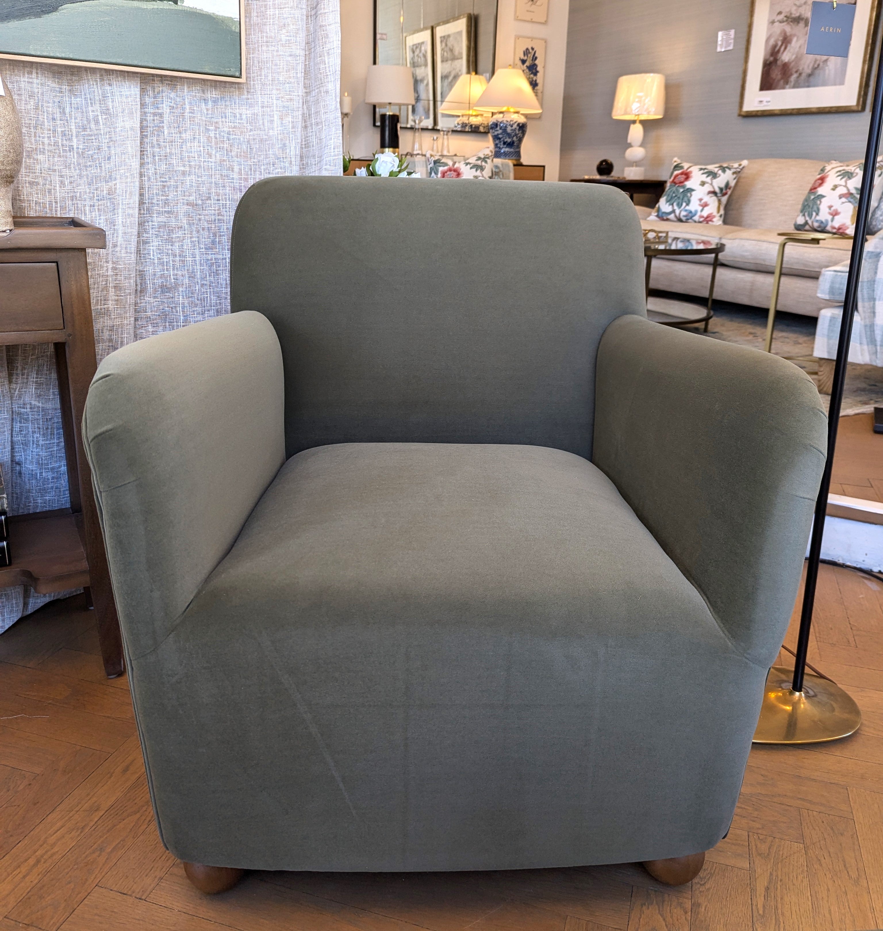 Felix Olive Armchair with a soft to the touch olive velvet and oak sphere legs. 