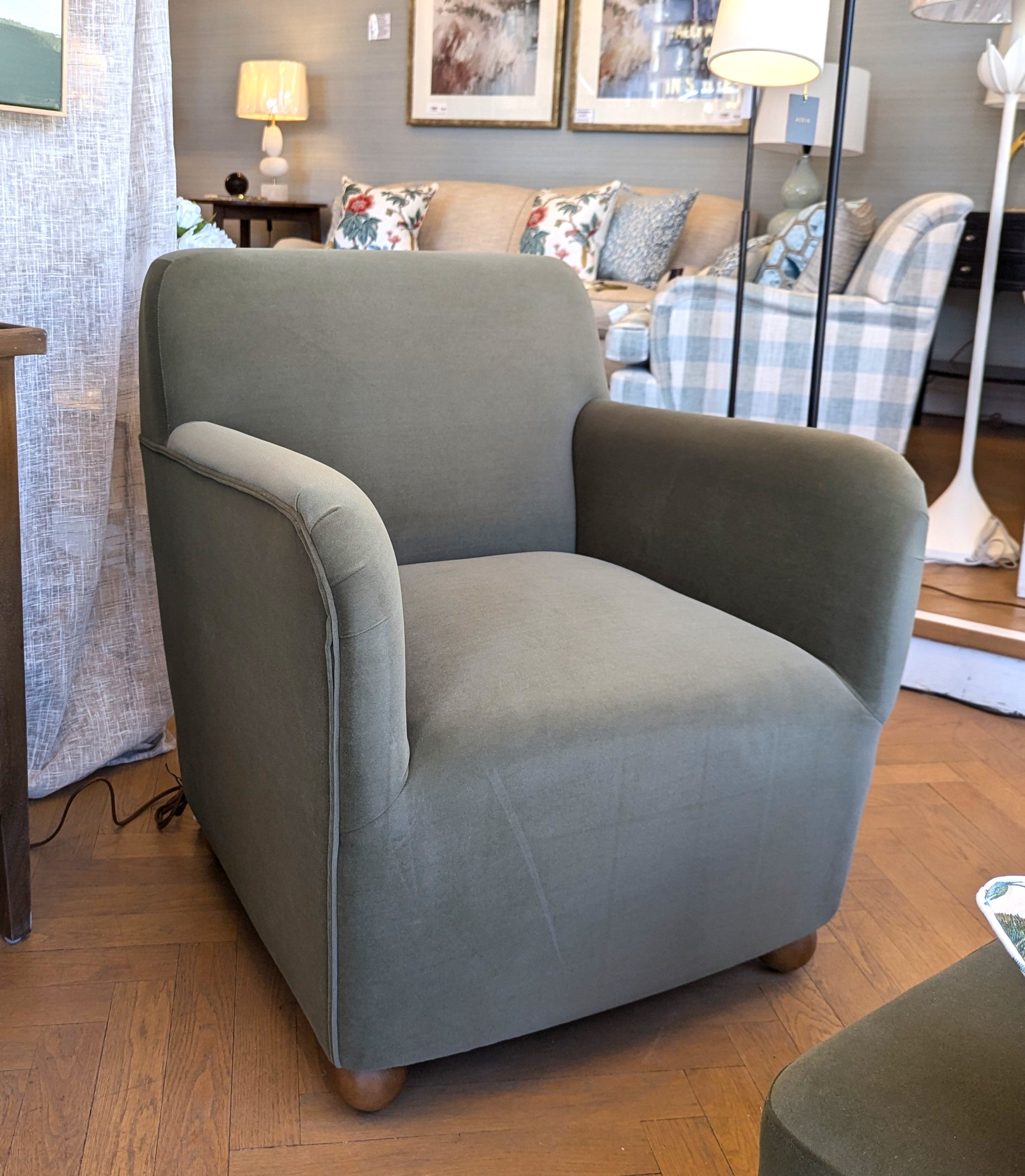 Felix Olive Armchair with a soft to the touch olive velvet and oak sphere legs. 